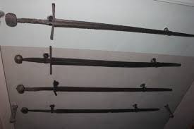 An Image of a Few Swords hanging on a wall